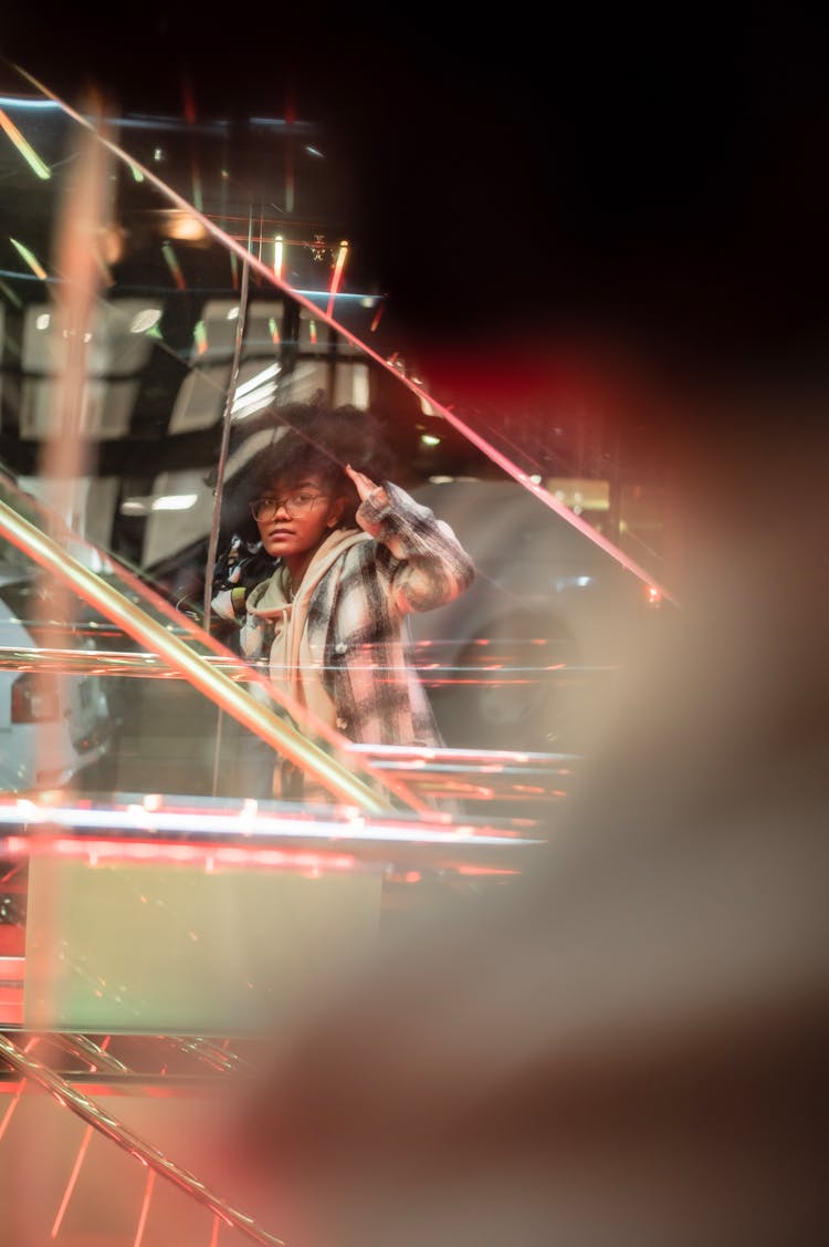 Window Reflection Of Black Lady Near Shop With Escalator