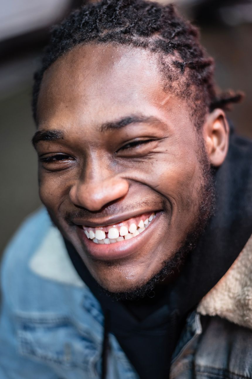 Close-up portrait of a laughing man in a denim jacket — photo by PNW Production on Pexels