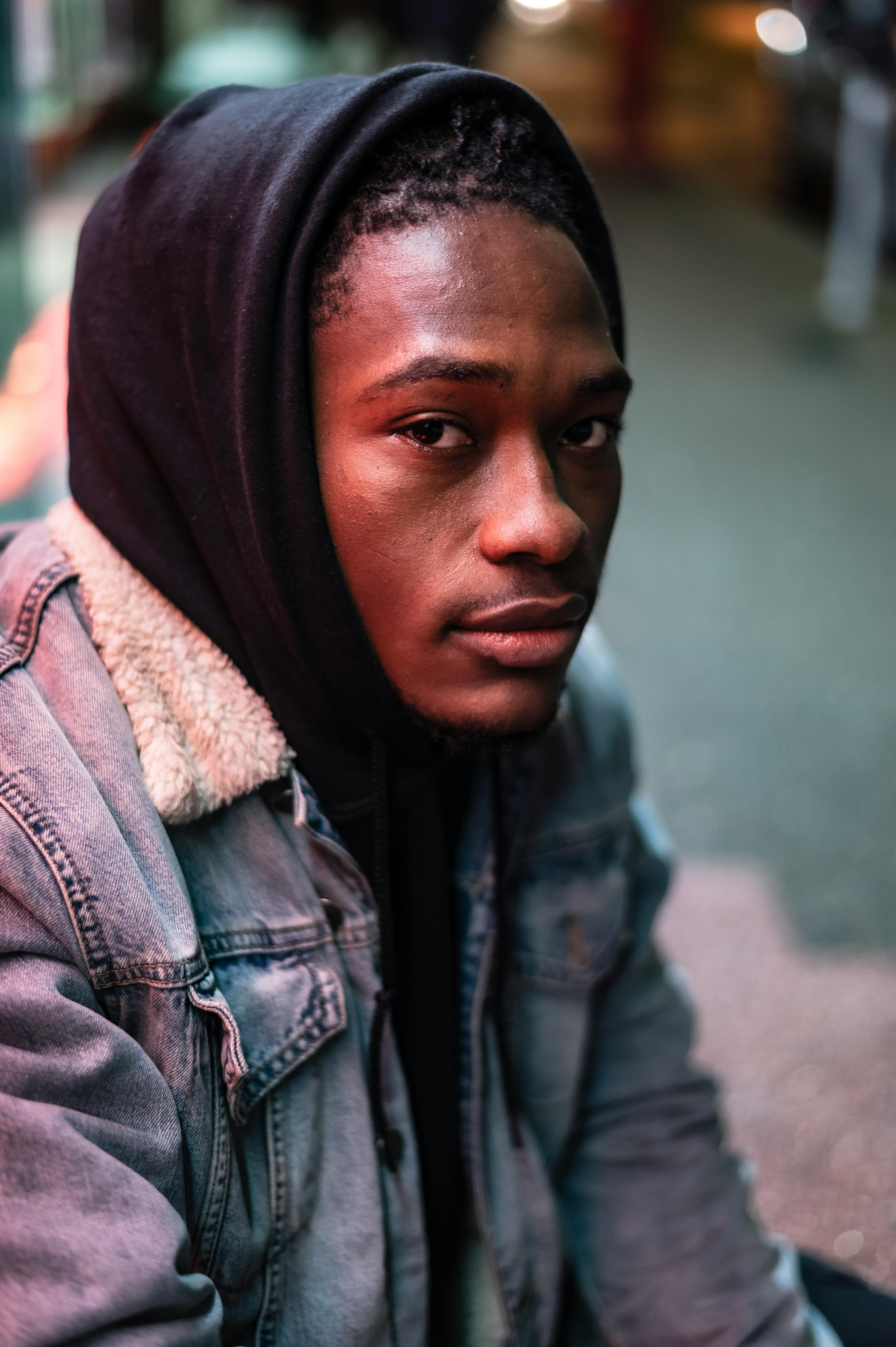 Stylish black man sitting on haunches on street · Free Stock Photo