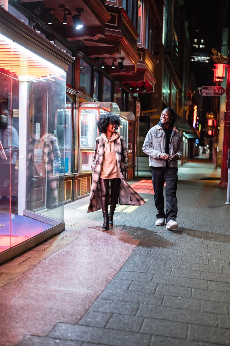 Stylish Black Couple Walking On Sidewalk