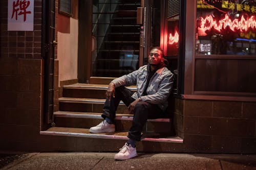 Self assured young man sitting on stairway