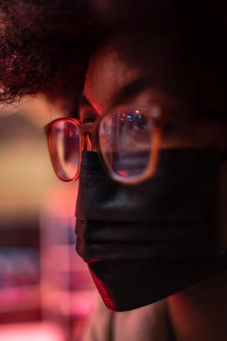 Crop Ethnic Woman In Fabric Mask And Eyewear At Night