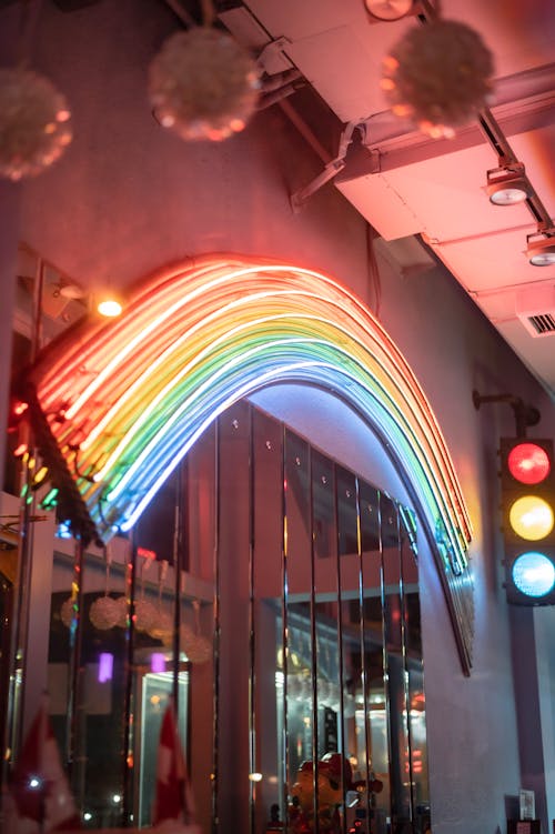 Rainbow lamp on modern building wall in evening