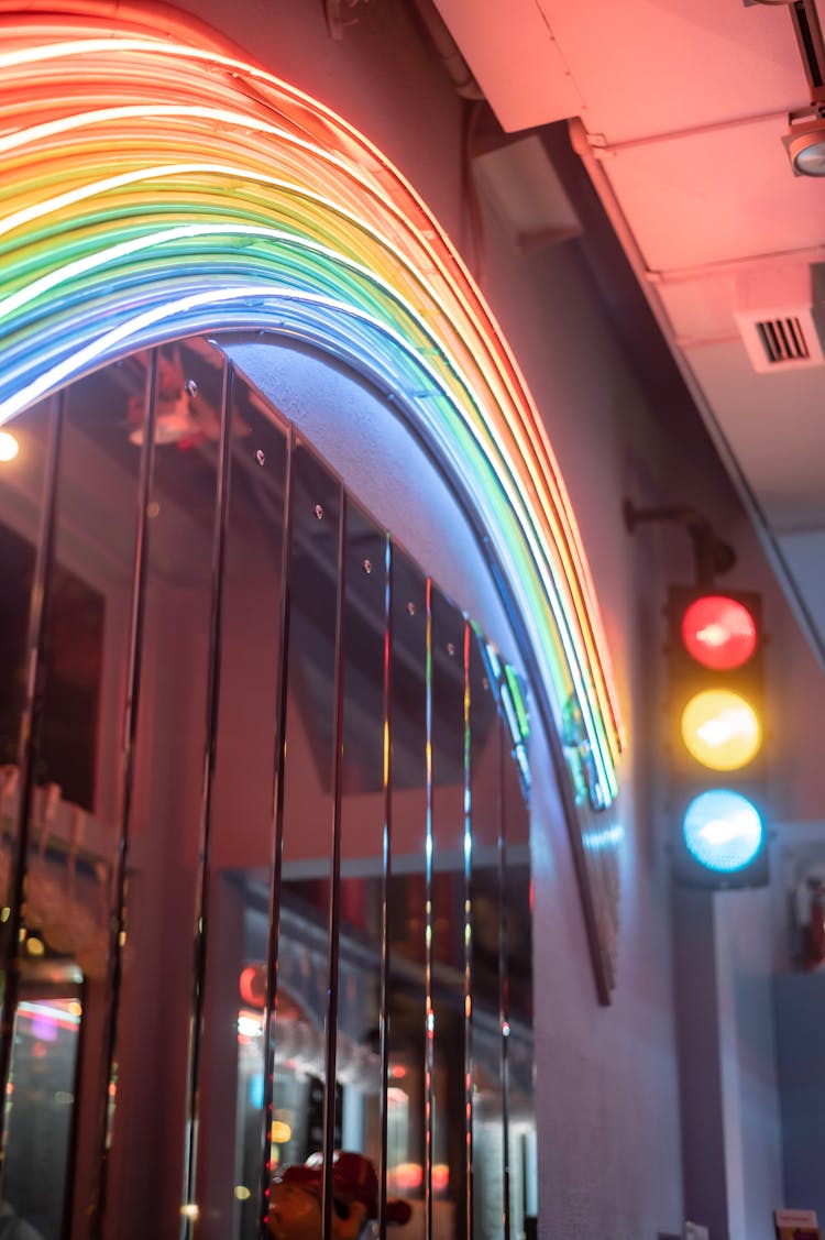 Neon Lights With Spectrum Ornament On Building Wall At Dusk