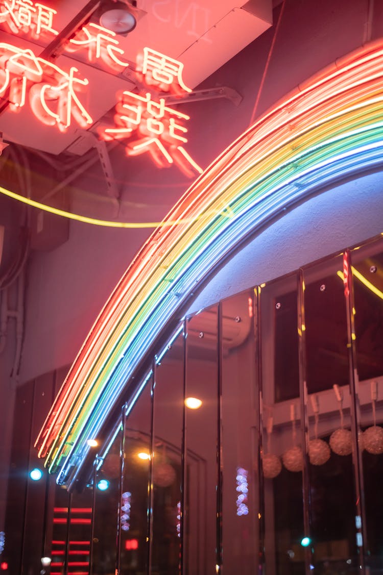 Rainbow Lamp On Building Wall Against Hieroglyphs At Night