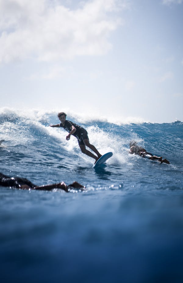 Man in Black Shorts Surfing on Sea Waves