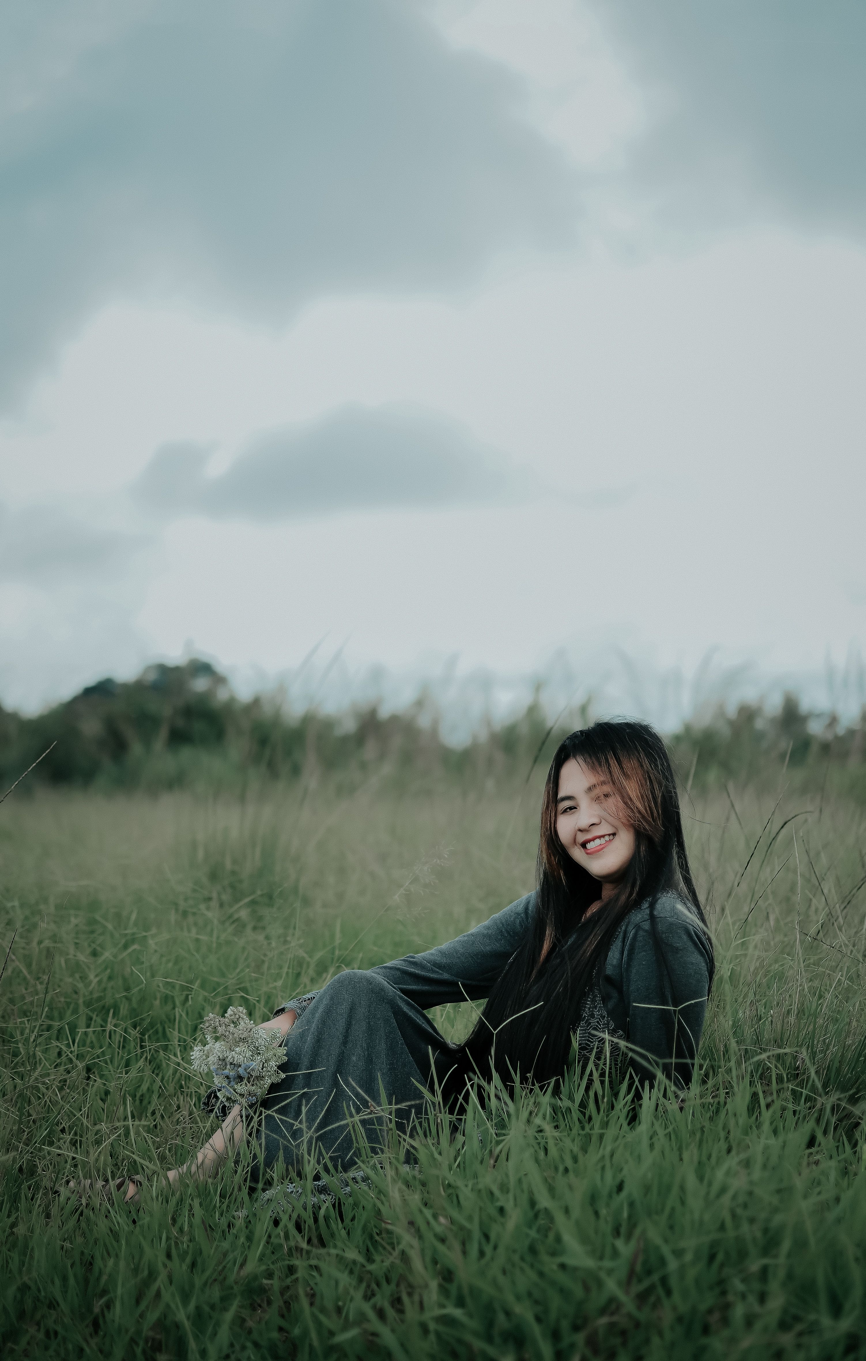 Woman Wearing Black Hijab Sitting on Grass Field · Free Stock Photo