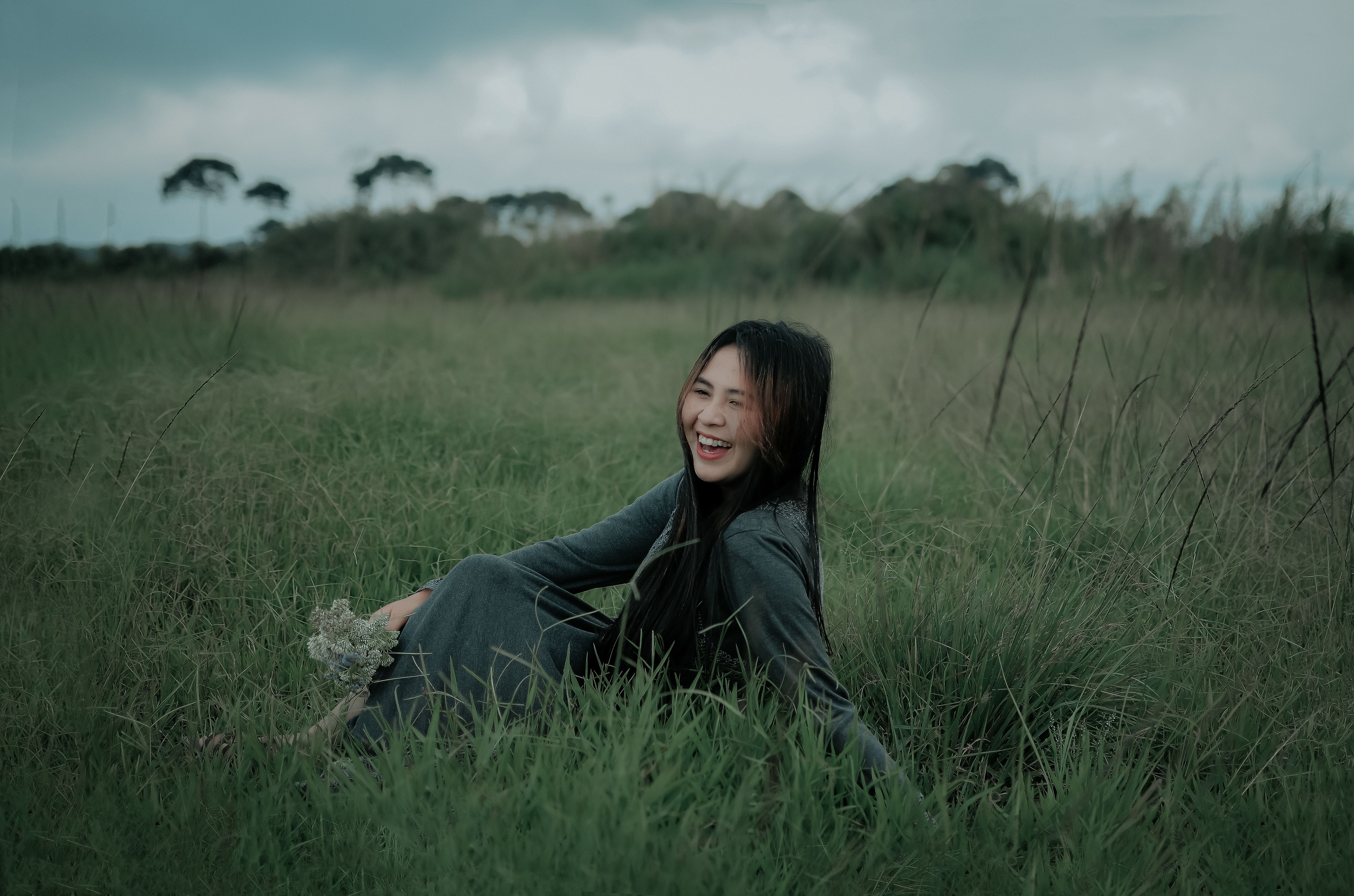 Woman Wearing Black Hijab Sitting on Grass Field · Free Stock Photo