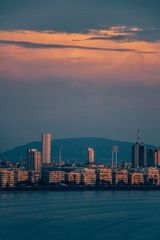 Mumbai's skyline at twilight, reflected
