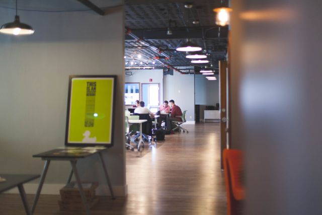 Contemporary open office space with people collaborating and working together. Related image for What Hospitality Leaders Should Know About Digital Guest Journeys.