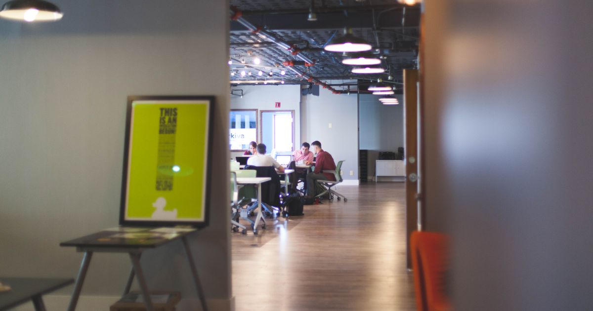Contemporary open office space with people collaborating and working together.