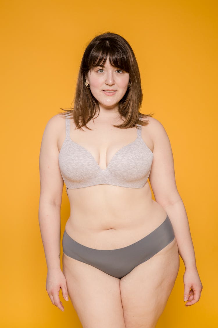 Overweight Asian Model In Lingerie On Yellow Background