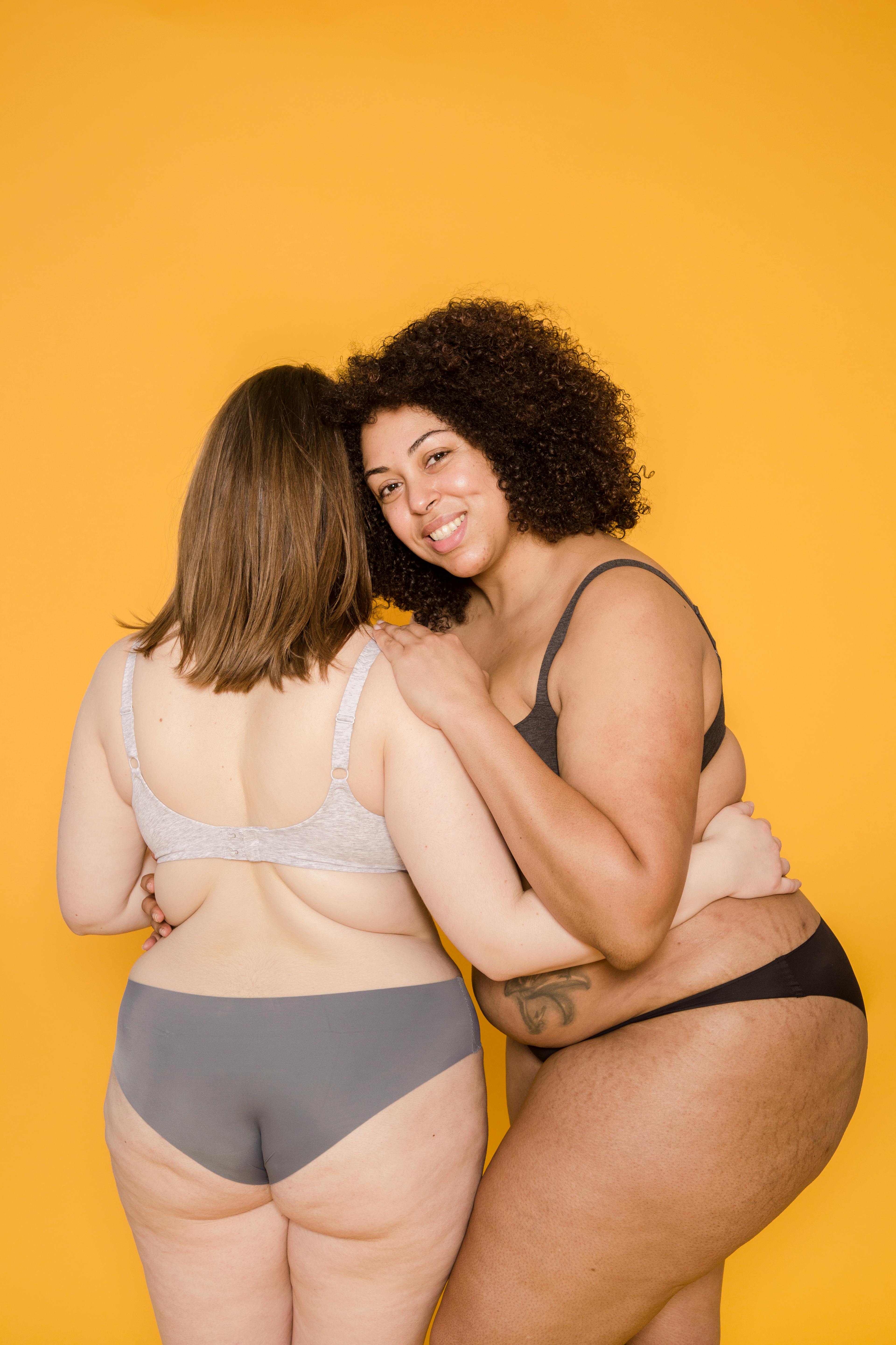 Slim African American Woman in Underwear Sharing a Secret with Her Plus Size  Friend, Standing Together Isolated Over Stock Photo - Image of emotion,  friends: 218940838