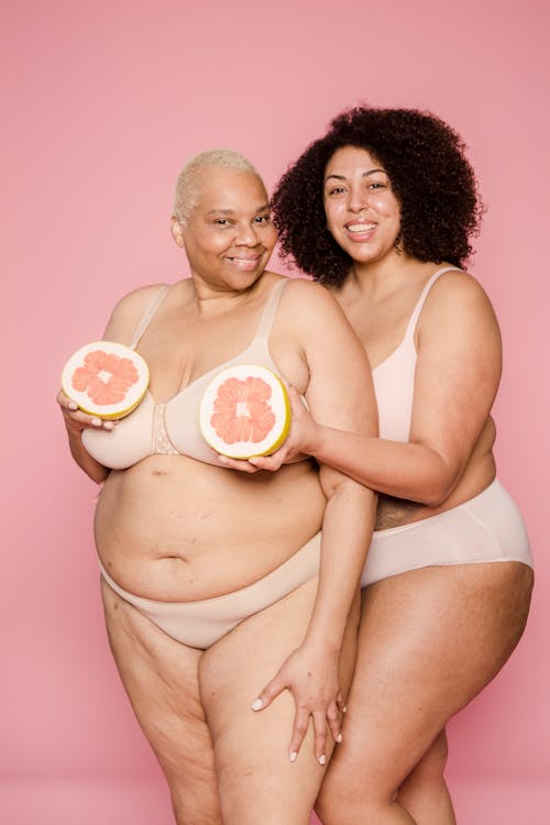 Plump black women in underwear with grapefruit in hands