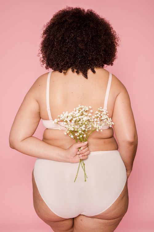 Anonymous plump black woman in underwear with flowers · Free Stock 