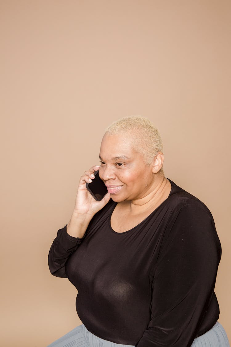 Cheerful Plump Black Woman Talking On Phone