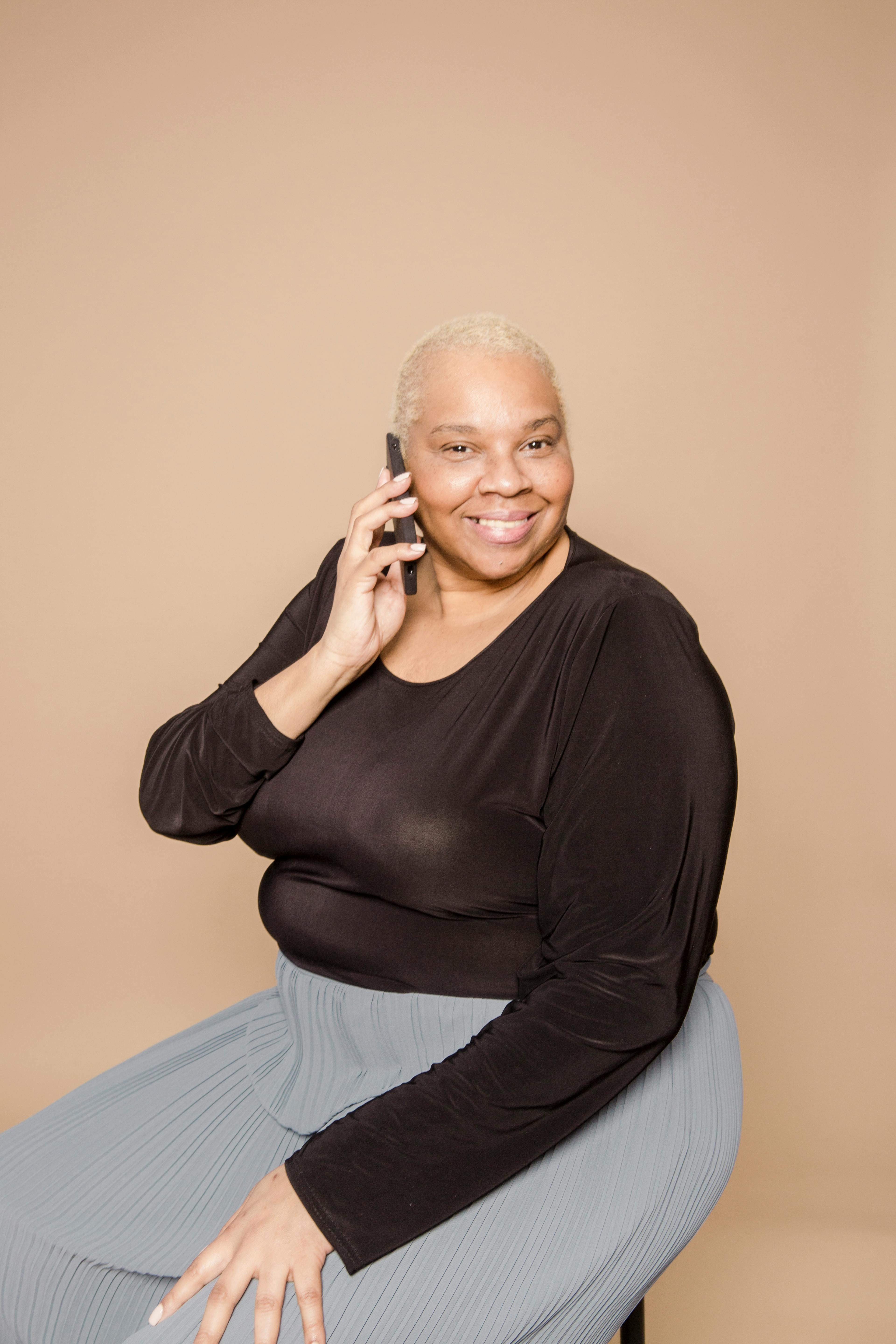 smiling plump black woman having phone call