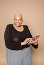 Smiling plump black woman with tablet