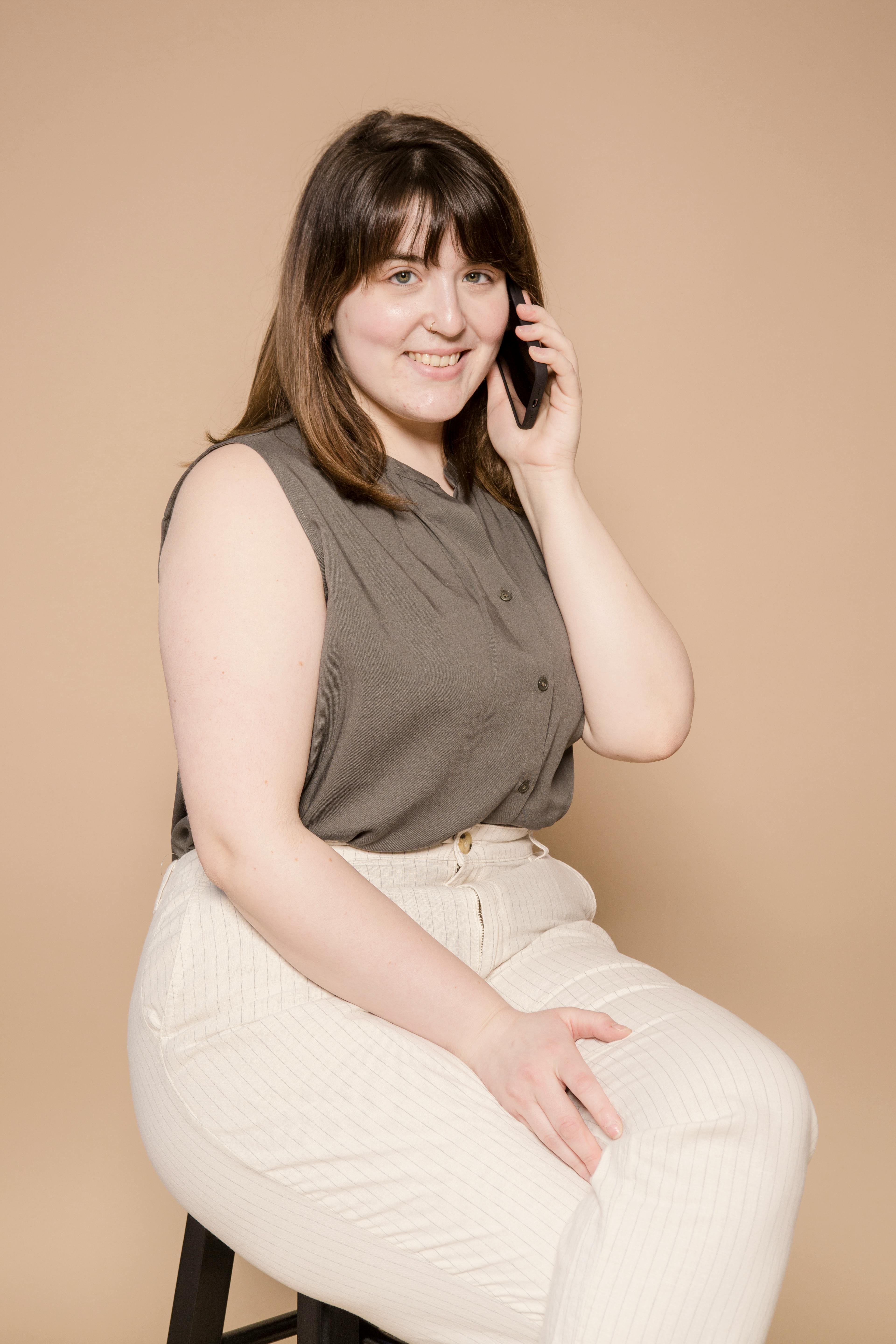 cheerful plump asian woman talking on phone