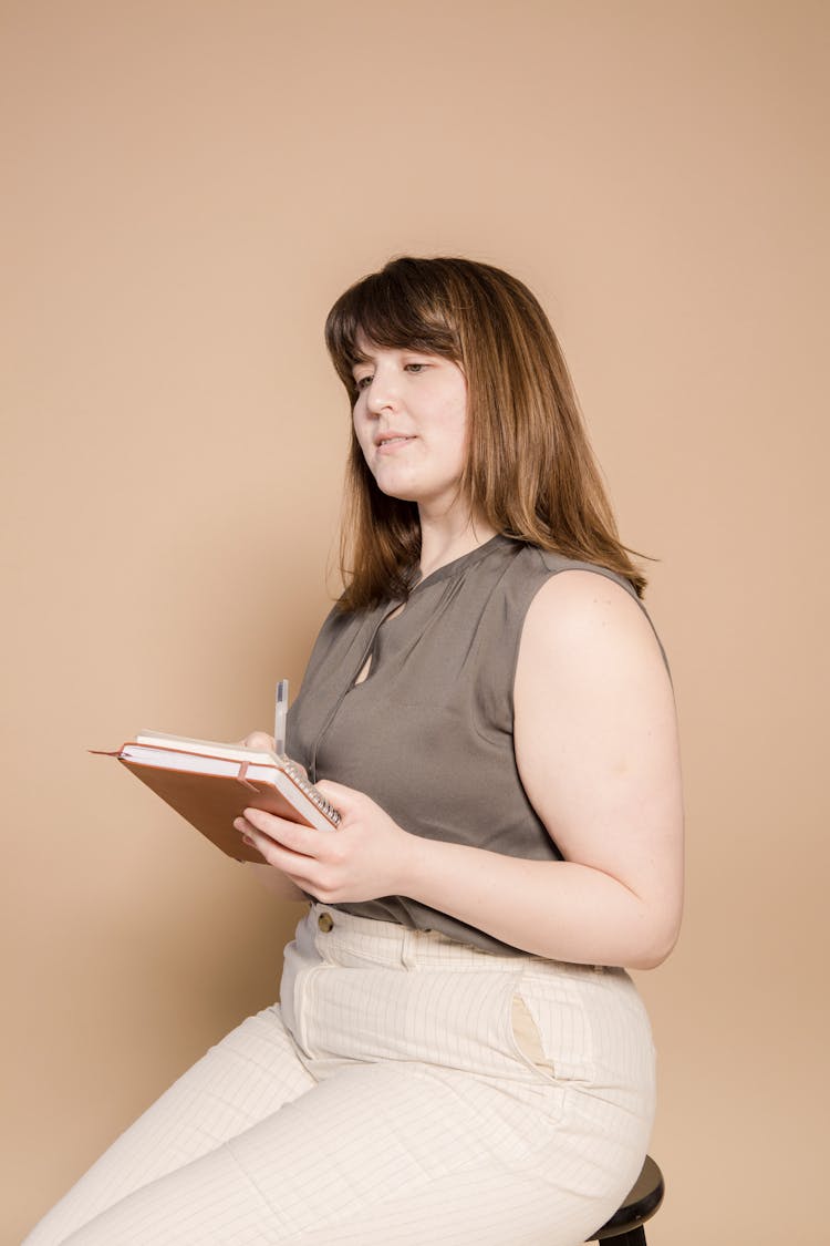 Pensive Overweight Asian Woman With Notepad