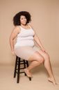 Content overweight black woman on chair