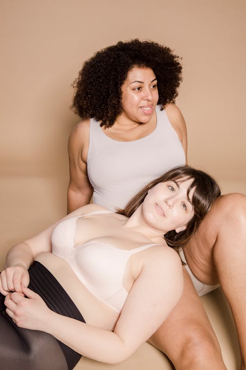 Overweight diverse women wearing underwear in studio