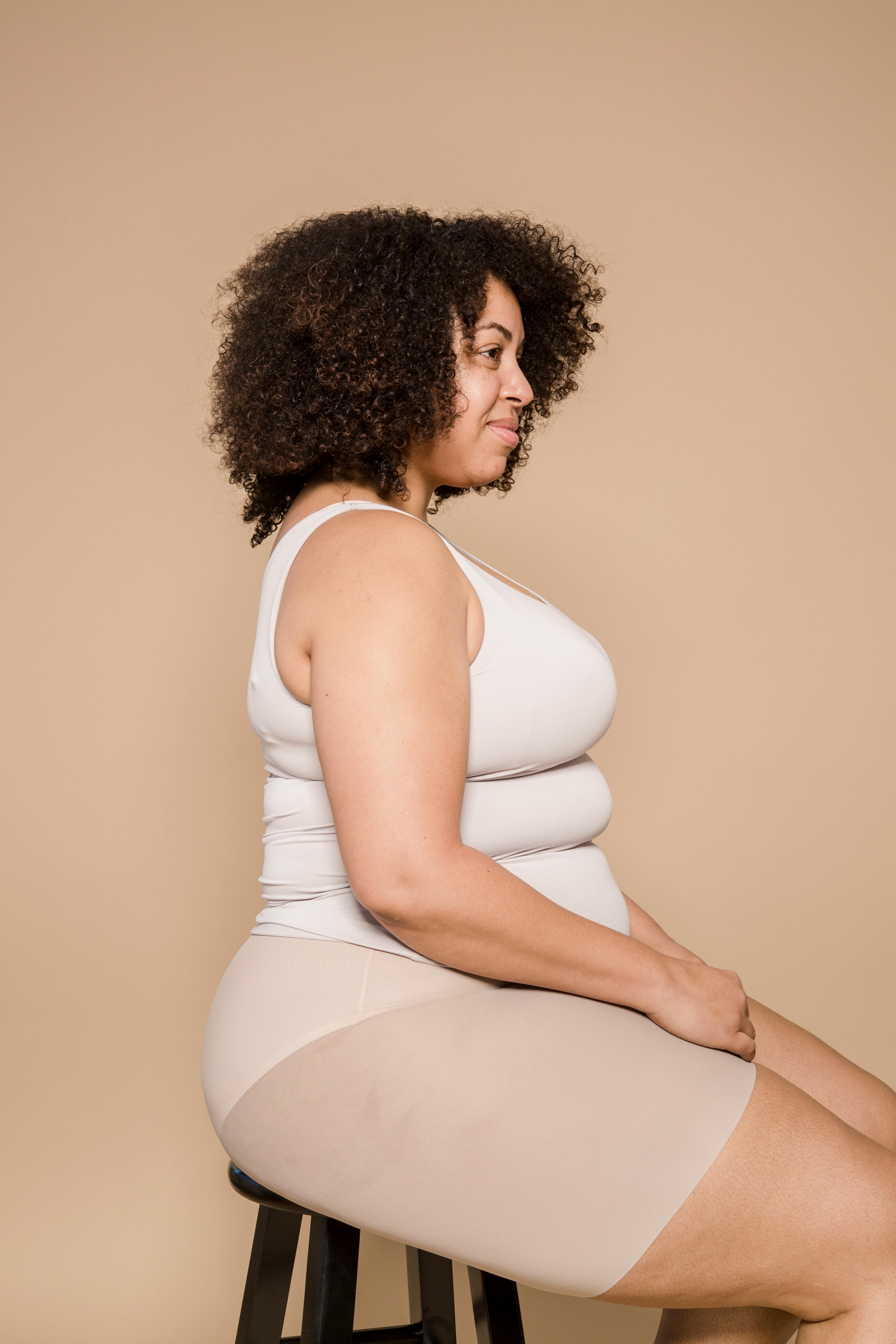 Overweight black woman sitting in studio · Free Stock Photo