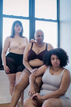 Three diverse women in lingerie showcasing body positivity and self-confidence.