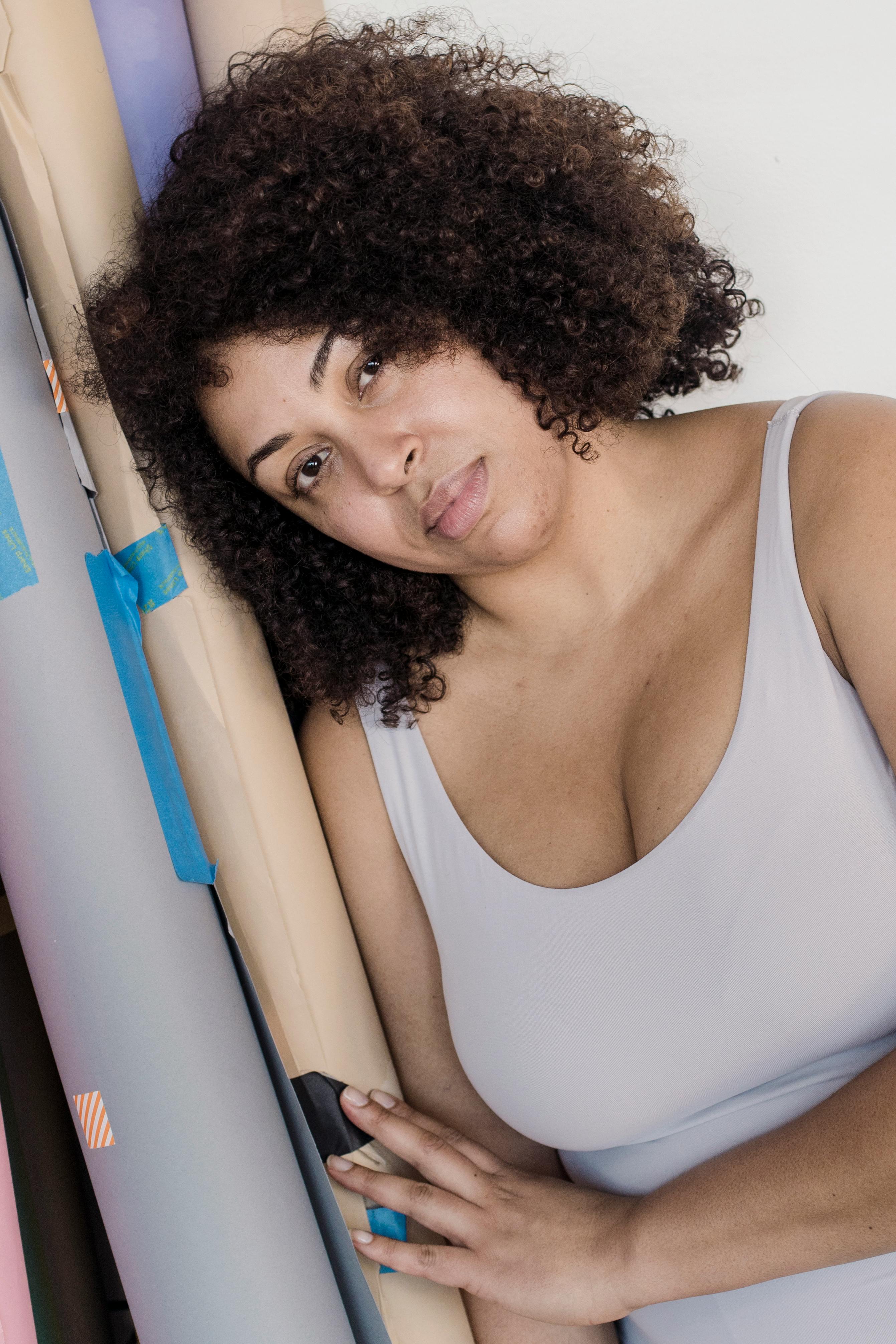 plus size ethnic model leaning on paper rolls