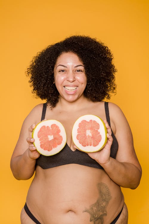 Woman Wearing Black Bra Holding Sliced Fruits