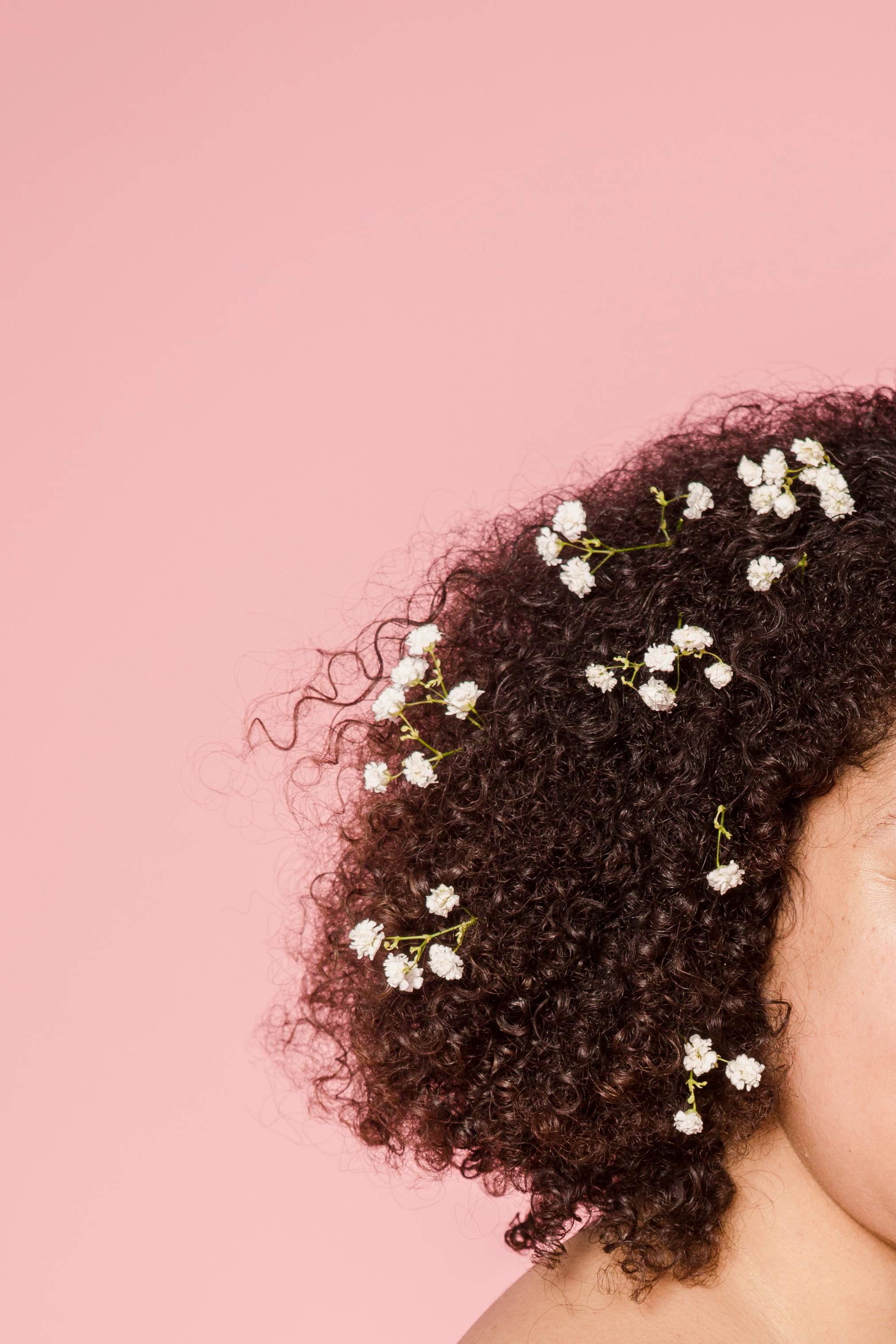 naked overweight black woman with flowers twigs in hair