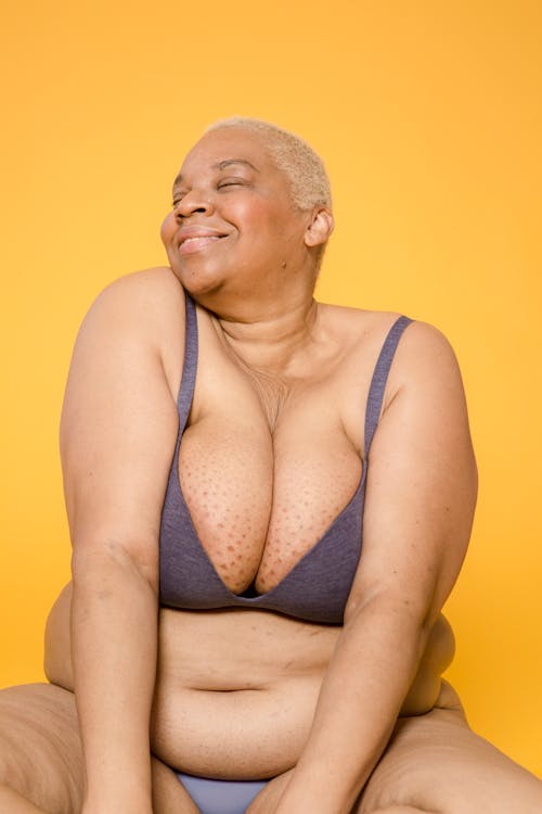 Happy plump black woman in underwear