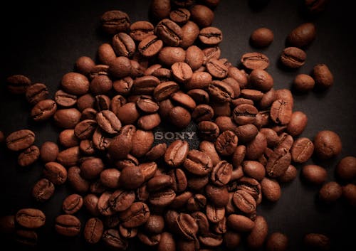 Free Coffee Beans on Top of a Sony Product Stock Photo