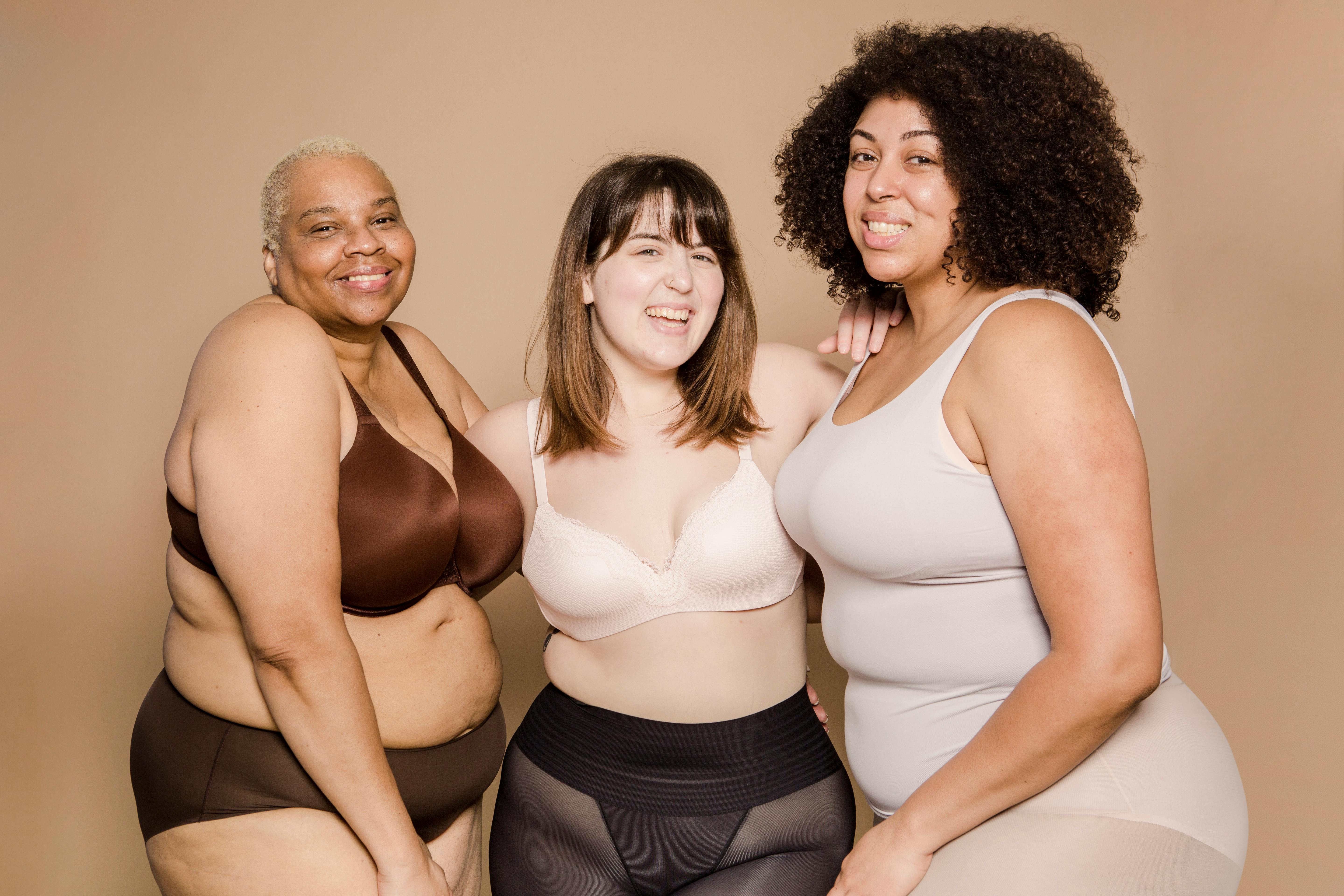 Happy diverse overweight women smiling together in beige studio · Free  Stock Photo