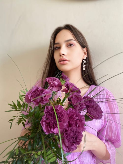 A Beautiful Woman Holding Purple Flowers