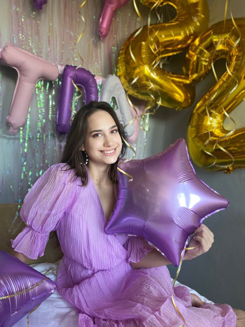 Free Woman in Purple Dress Holding a Balloon Stock Photo