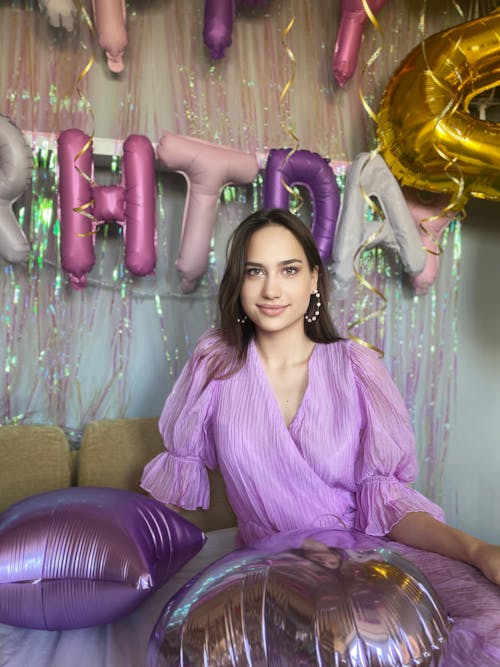 A Young Woman Posing with Birthday Decorations