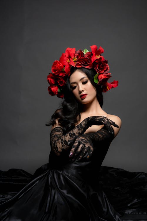 A Pretty Woman in Black Dress with Red Flower Headdress