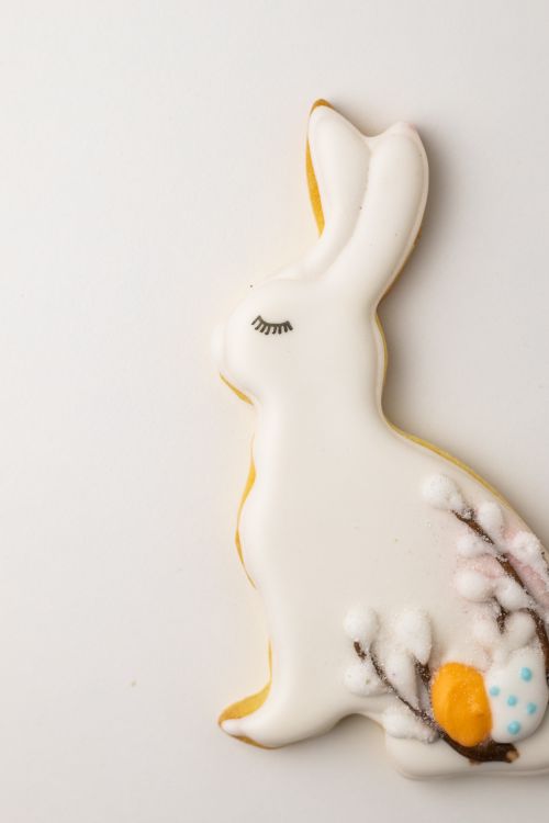 Free Close-up of a white Easter bunny cookie, decorated with flowers and eggs. Stock Photo