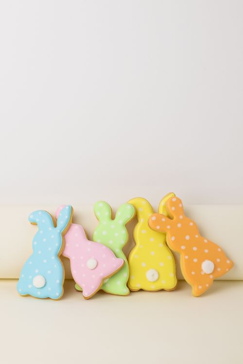 Free Vibrant Easter bunny-shaped cookies in pastel colors lined up in a vertical shot, perfect for Easter celebrations. Stock Photo