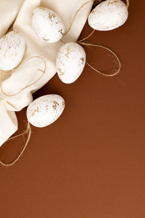 White Eggs on a Brown Surface