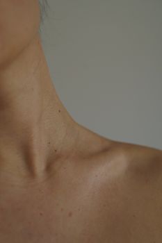 Natural close-up image of a human neck and clavicle highlighting skin texture and anatomy.