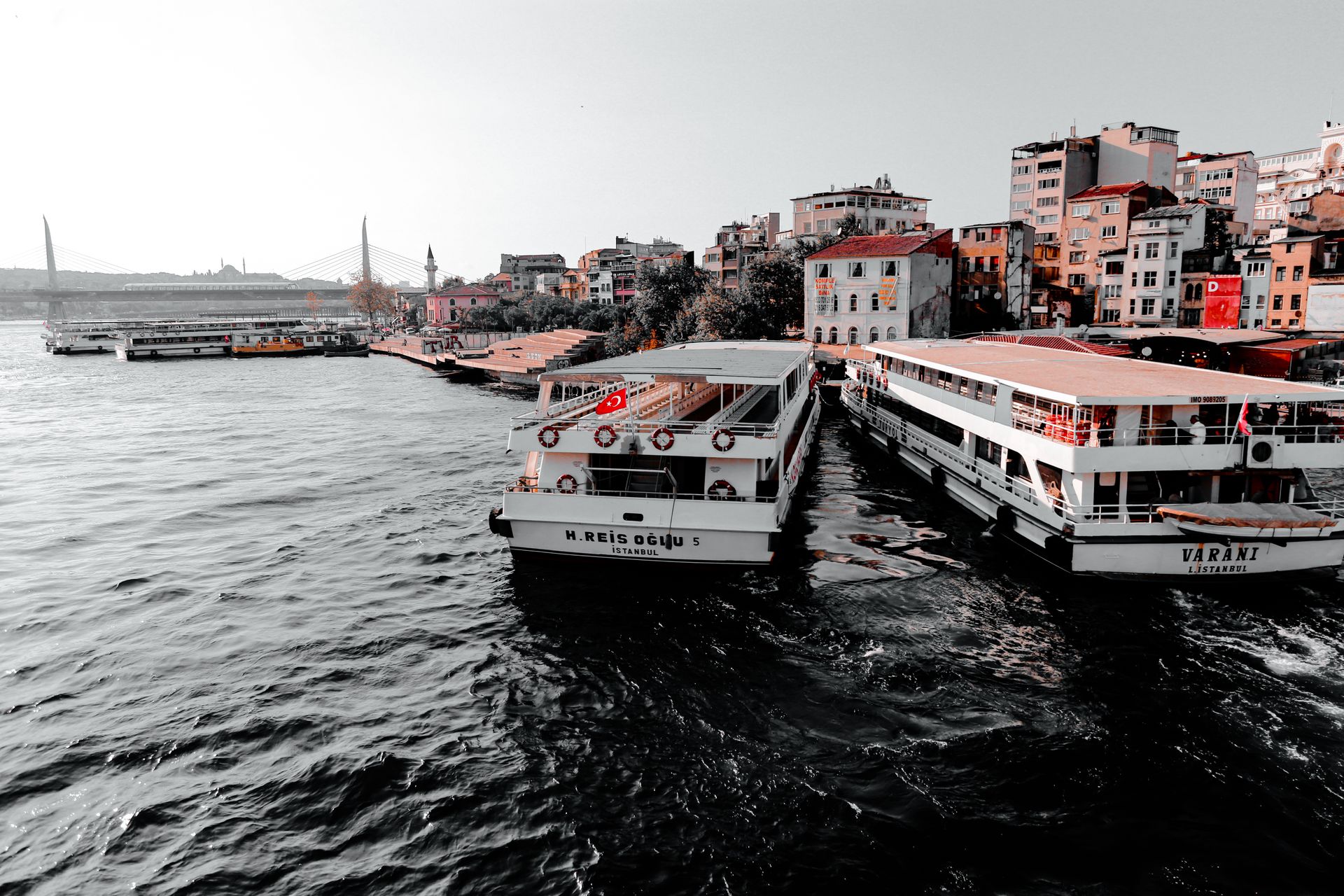 Colorful waterfront scene with docked ferries in vibrant Istanbul.