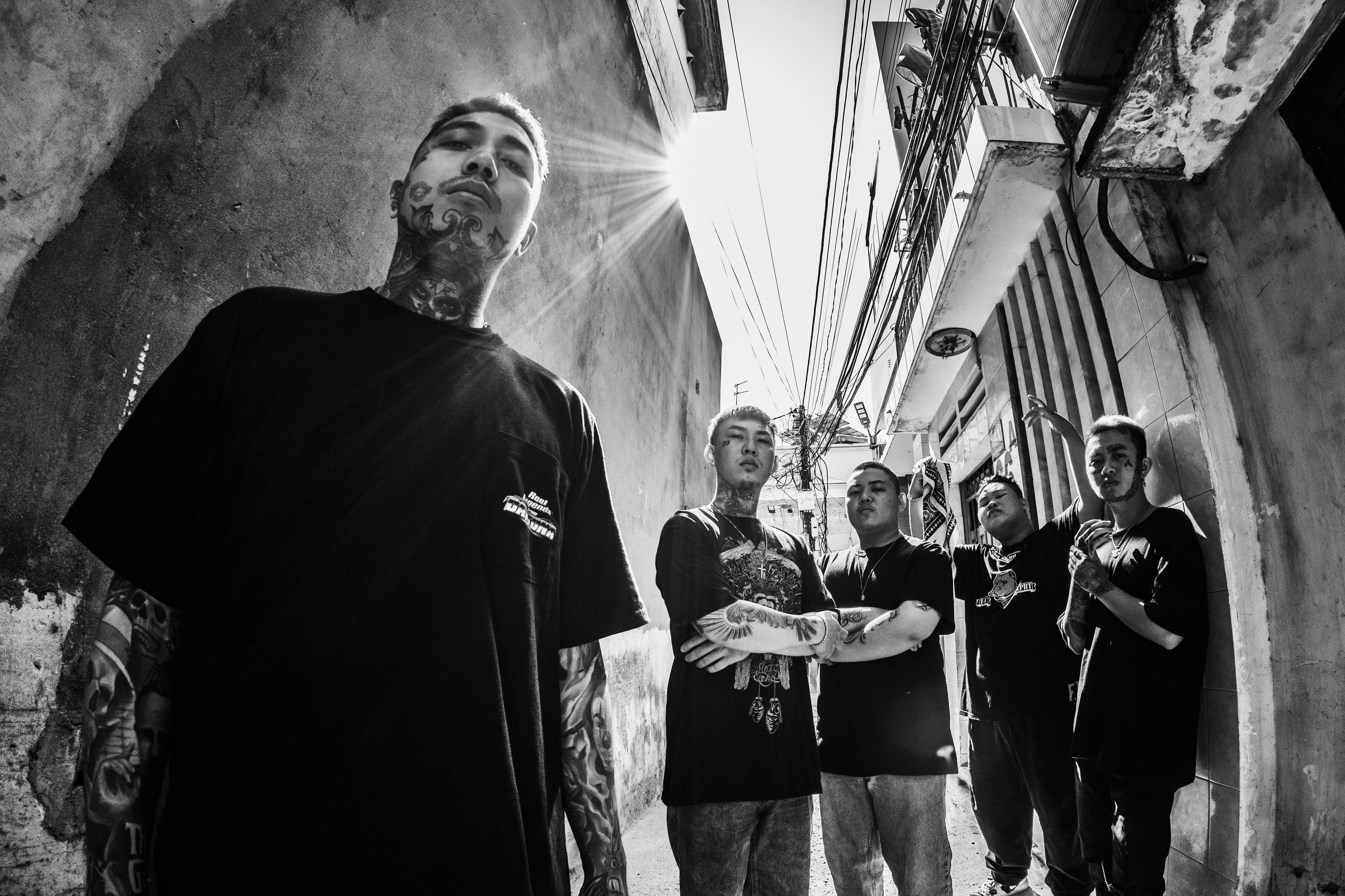 gang of friends with tattoos on street sunbeams.