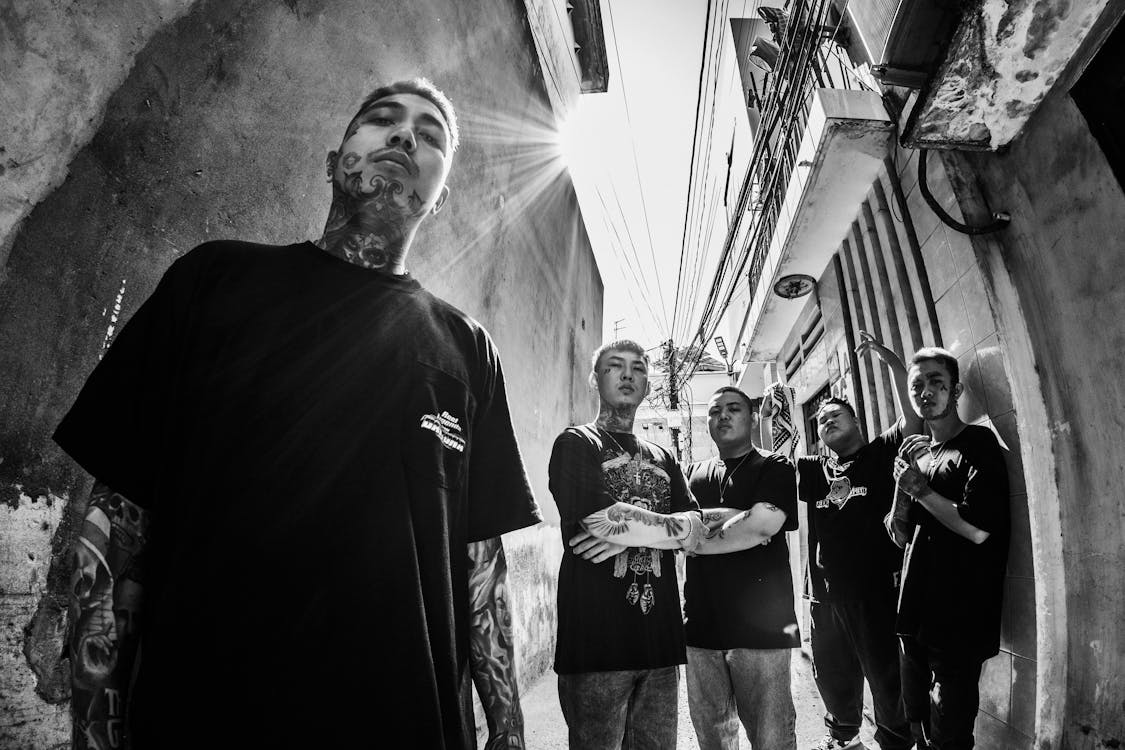 gang of friends with tattoos on street sunbeams.