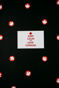 A minimalist design featuring 'Keep Calm and Love Canada' and maple leaf symbols.