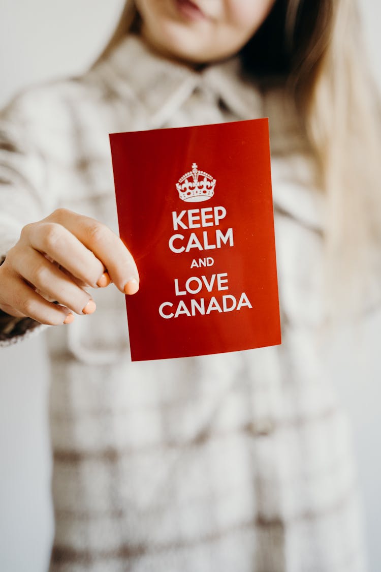 A Person Showing Card With A Keep Calm Quote