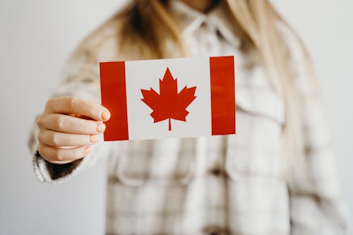 Free Person Holding a Canadian Flag Stock Photo