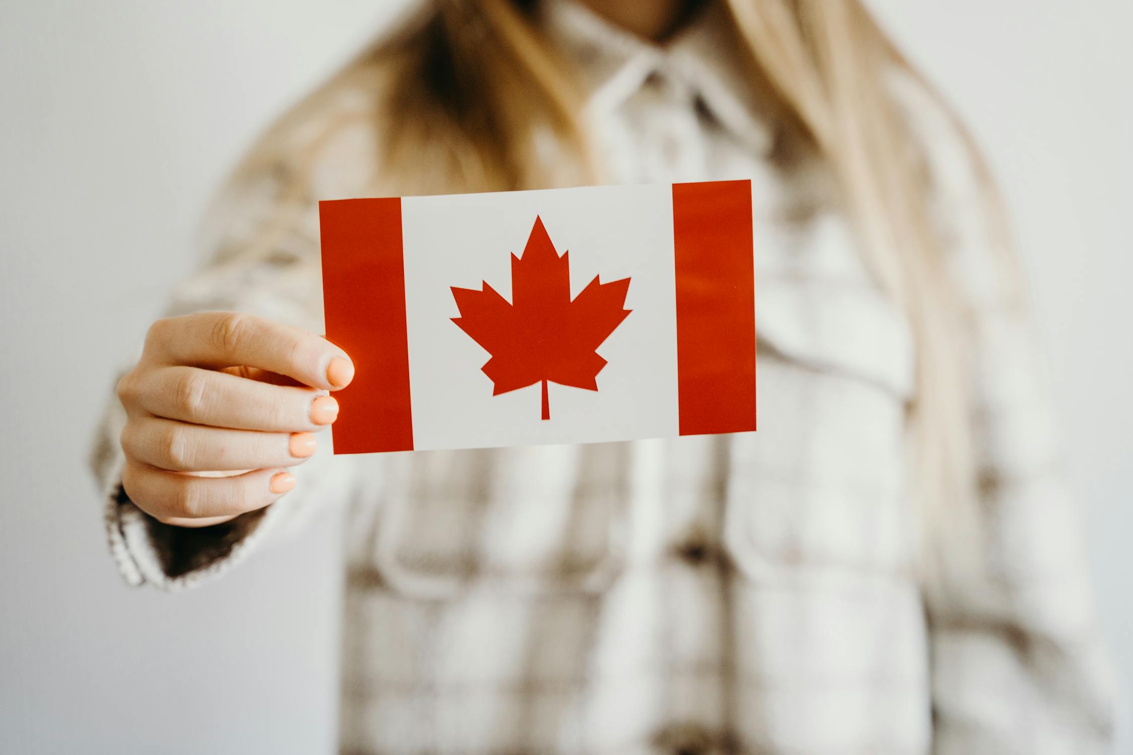 Person Holds Small Canadian Flag