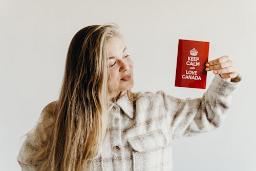 Woman Looking at the Red Card with Message she is Holding